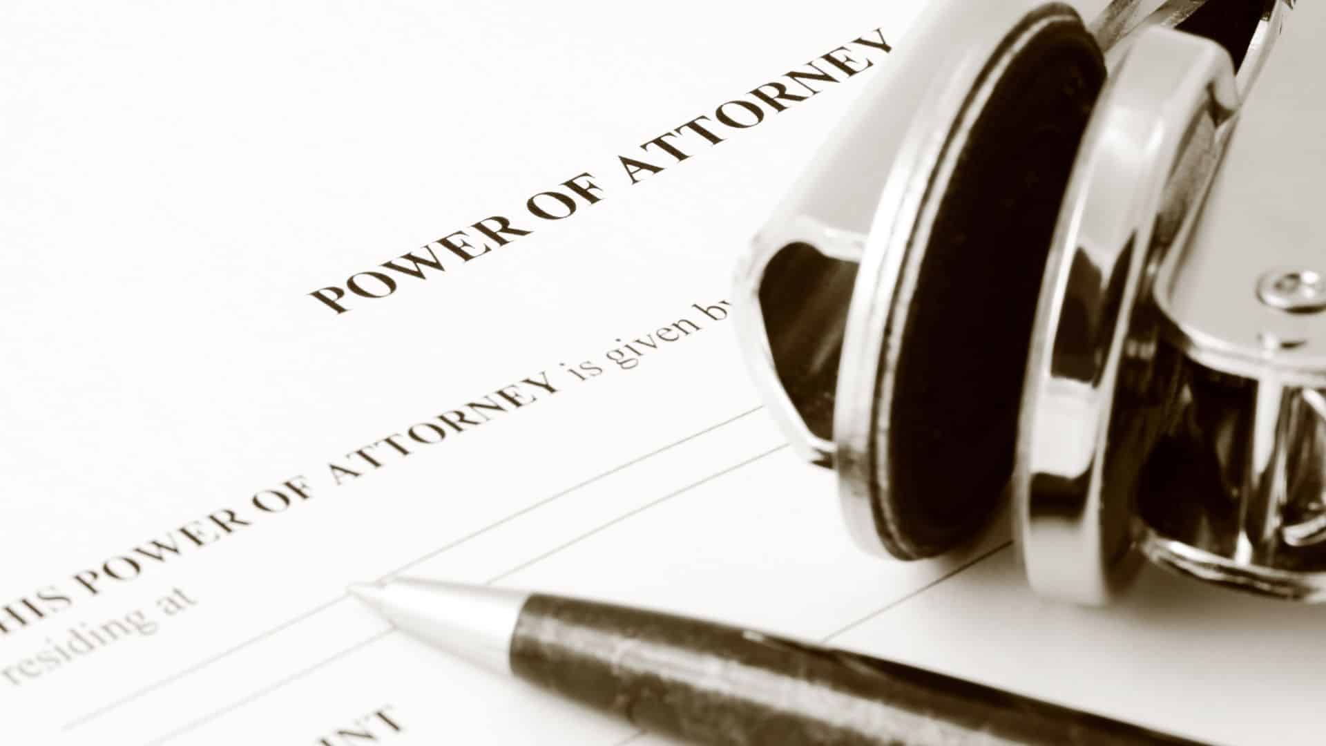 Close up of a Power of Attorney form with a pen and stamp at the corner of the frame