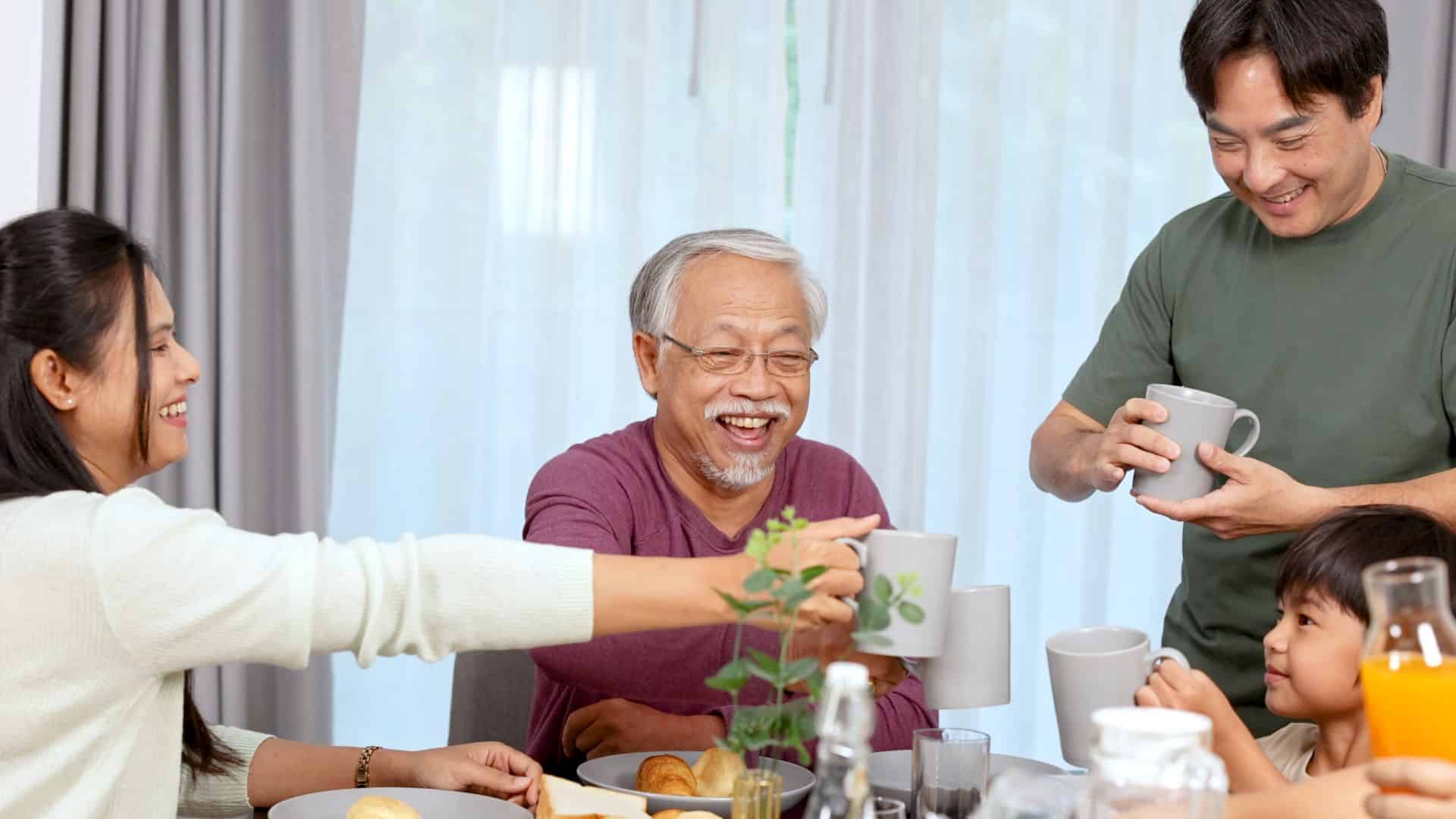 A multi-generational Asian-American family enjoying a meal together.